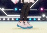 a person wearing a pair of white sneakers with blue sole