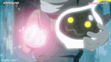 a person is holding a glowing object in their hands with the time 9:20