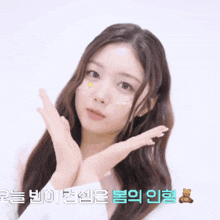 a woman with a teddy bear on her face is making a face with her hands