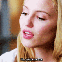 a close up of a woman 's face with the words you are beautiful