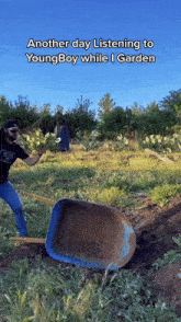 a man is pushing a wheelbarrow in a field with the caption another day listening to youngboy while i garden