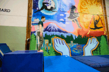 a man is doing a trick in front of a mural that says " ward "