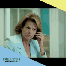 a woman in a blue jacket talking on a cell phone