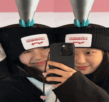 a girl taking a picture of herself with a phone that says yobbevo on it