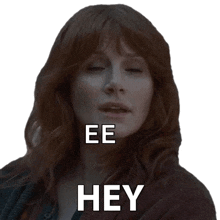 a woman with red hair says eee hey in front of her face