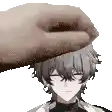 a person is putting their hand on a boy 's forehead .