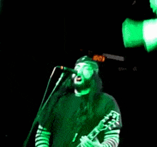 a blurry image of a person in a green outfit