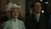 a man and a woman are standing next to each other with hbo written on the bottom