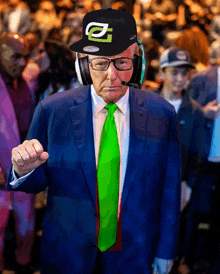 a man in a suit and tie wearing headphones and a hat with the letter a on it