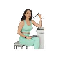 a woman is sitting on a stool holding glasses