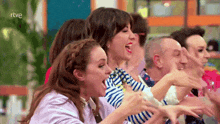 a group of people are laughing with the letters rtve in the corner