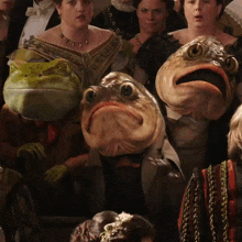 a group of people are dressed in costumes with frogs and fish on their faces