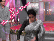 a woman in a silver dress is dancing in front of a man in a grey shirt and the words " do orat dance "