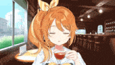 a girl with orange hair is sitting at a table holding a cup of tea