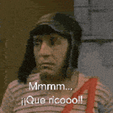a man wearing a hat and a striped shirt says mmmm que ricooo !