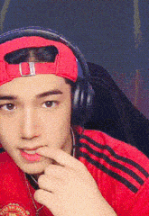a man wearing headphones and a red hat with the word united on it