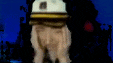 a blurry picture of a man wearing a white hat with the letter m on it