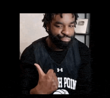 a man with a beard is giving a thumbs up .