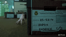 a hand is sticking out of a box that says kansas city police department on it