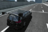 a black car is driving down a highway with the trunk open