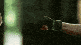 a close up of a person 's fist with a green background