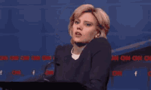 a woman smoking a cigarette while giving a speech