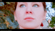 a close up of a woman 's face with a logo for liliee man productions