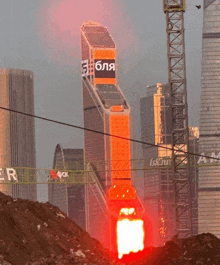 a rocket is being launched in front of a building that has a sign that says ' 3 bla ' on it