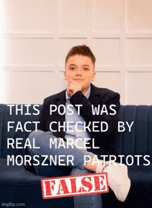 a boy is sitting on a blue couch with a false stamp on the bottom