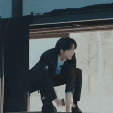 a man in a suit is standing on a pole