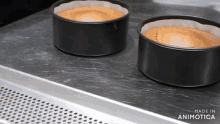 two cakes are sitting on a tray with the words made in animotica on the bottom right