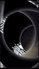 a black and white photo of a circular object with a light coming out of it