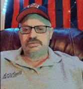 a man wearing glasses a hat and a shirt that says bagcock on it