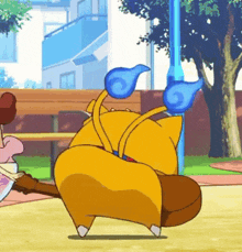 a yellow cartoon character with blue wings is dancing in a park .