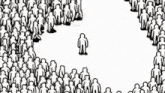 a large group of people are standing in a circle and one of them is standing in the middle .