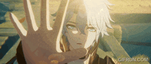 a gif from gifrun.com shows a boy with a hand covering his face