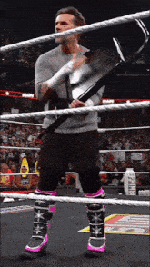 a man in a wrestling ring holding a hammer with the word prime on it