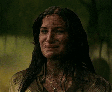 a woman with a spider on her head is smiling in the dark