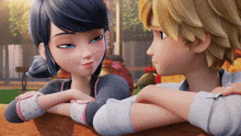 a boy and a girl are looking at each other and holding hands .