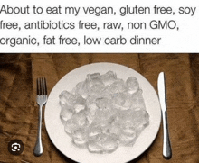 a plate of ice cubes with a knife and fork on a table .