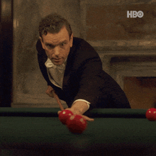 a man in a tuxedo playing pool with the words that won 't happen again above him