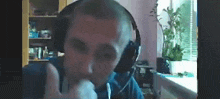 a man wearing headphones and giving a thumbs up