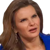 a close up of a woman 's face with a blue jacket and earrings