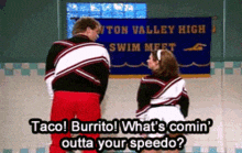 a couple of cheerleaders standing in front of a sign that says taco burrito what 's comin outta your speedo