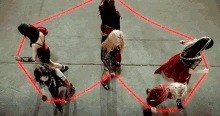 a group of women dancing in a circle with red lights
