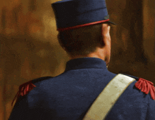 a man in a military uniform with red epaulettes