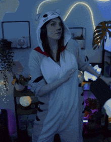 a woman in a cat costume is dancing in a room