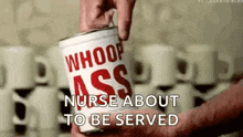 a person is holding a can of whoop ass soup .