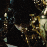 a close up of a person 's face with a lot of gold decorations around them