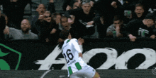 a soccer player with the number 26 on his jersey is celebrating